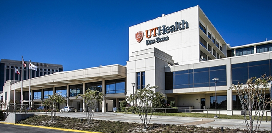 UT Health East Texas in Tyler, a modern medical building with large glass windows, a white facade, and landscaped surroundings.
